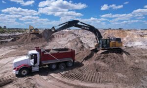 excavator filling truck with clean fill