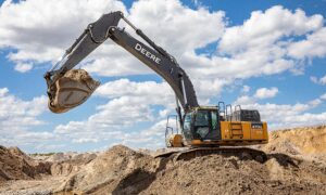excavator picking up unscreened fill dirt