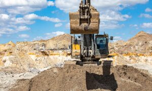 excavator working on picking up Florida clean fill dirt