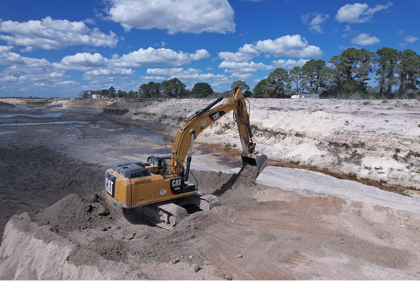 excavator picking up fill on mining site