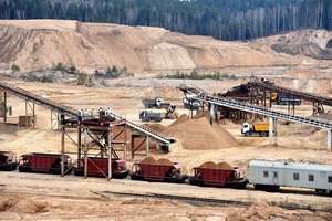 loading sand into freight cars of a train in quarry