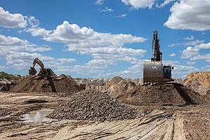 two excavators working on an aggregate mining site