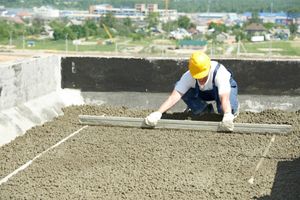 Carpenter measuring surface made from concrete and aggregate