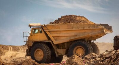 very large haul dump truck filled with dirt at a construction site