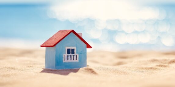 miniature model of a house standing on the sand on the Florida seacoast