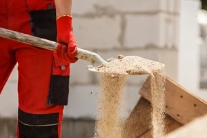 Punta Gorda, FL worker lifting sand with tool