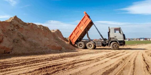 delivery of sand to the construction site by truck with raised body