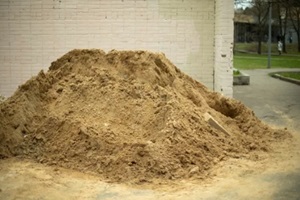 pile of landscaping sand near a house at construction site