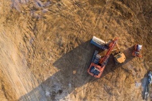 aerial view over heavy machinery on a building construction site