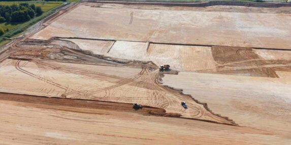 construction vehicles working on large dirt site