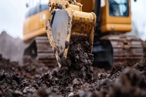 machine working with fill dirt in an construction site