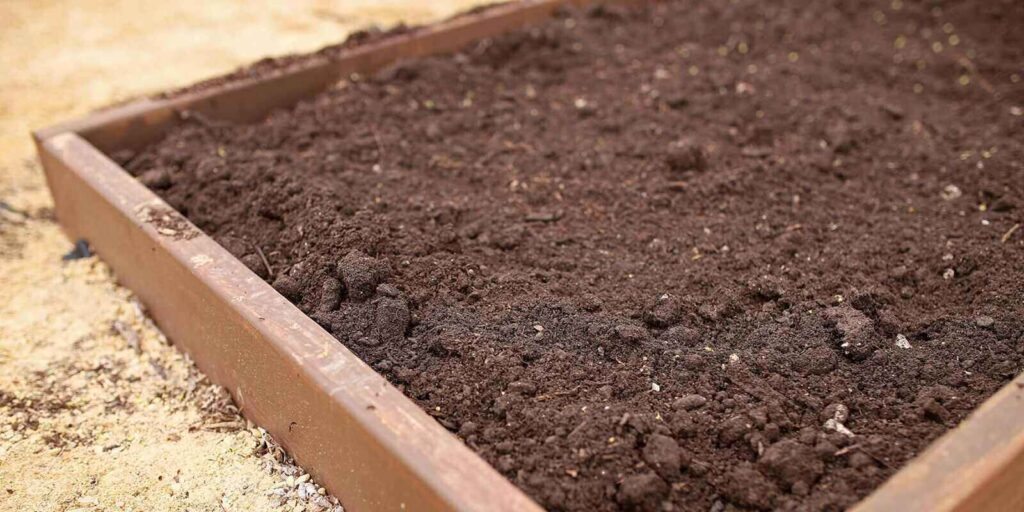 clean fill dirt in raised garden bed in spring