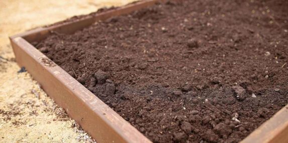 clean fill dirt in raised garden bed in spring