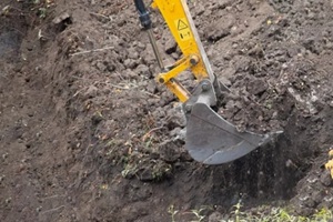 close-up of an excavator bucket filled with fill dirt during work in Punta Gorda, FL