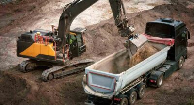 excavator loading fill dirt into a truck in central Florida
