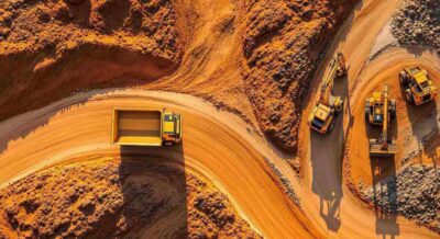 aerial view of construction vehicles on winding dirt road to Punta Gorda, FL quarry