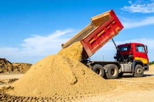 Dump Truck Unloading Locally Sourced Aggregate Sand in Lakeland, FL