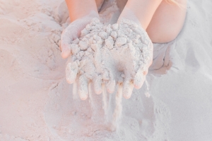 Hands Holding Pure White Sand