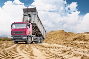 Dump Truck Unloading Fill Dirt at Construction Site