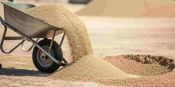 Wheelbarrow Tipping Fill Dirt on Site to Prepare Surface Before Sand Application in Lakeland, FL