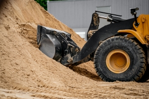 Loader Pushing Sand on Vollyball Court Site During Groundwork and Excavation