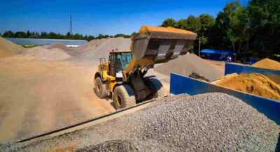 Piles of Different Construction Materials with A Loader