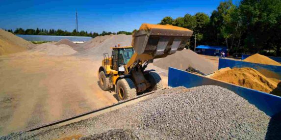 Piles of Different Construction Materials with A Loader